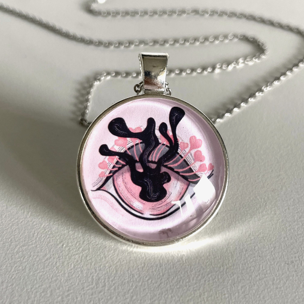 Handmade cabochon necklace with stainless steel chain and original art of a pink eye with distorted iris