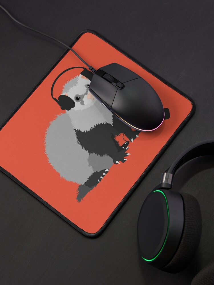 funny ferret with headphones on a mousepad