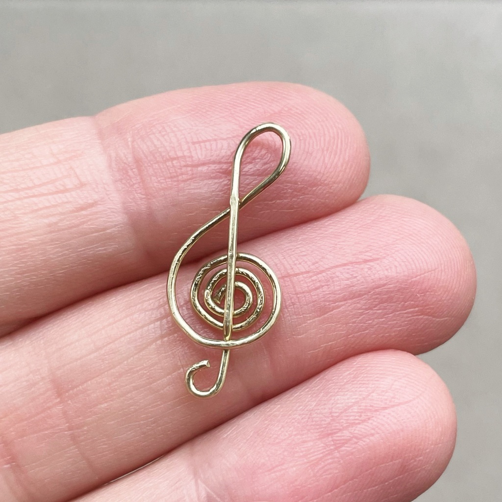 Treble clef charm crafted from yellow brass wire