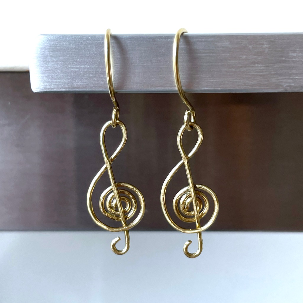 Handmade treble clef earrings crafted from brass wire